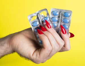 women holding erectile dysfunction tablets